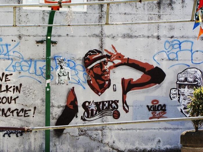 Mural of Basketball player in Sixers jersey on concrete wall